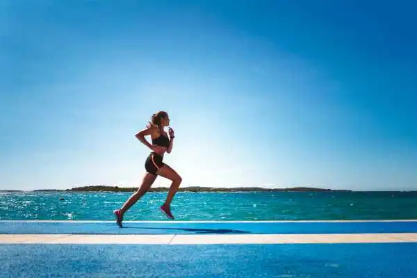 Woman running showing strong leg muscle Purfleet